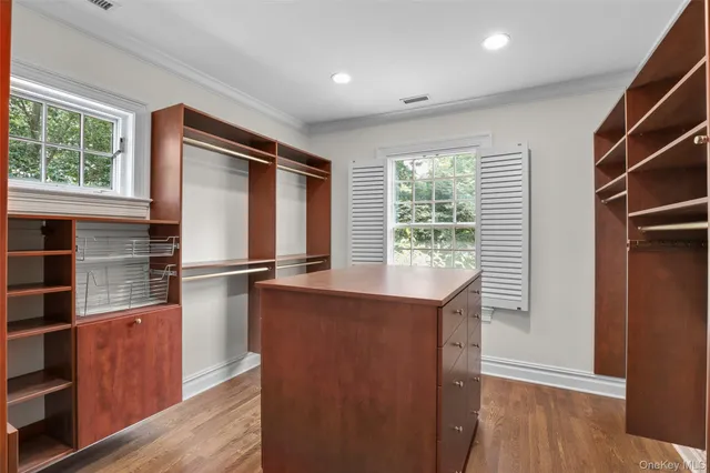 a kitchen with kitchen island a large window appliances and cabinets