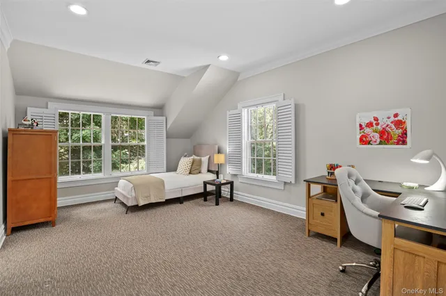 a bed room with a bed and a chair