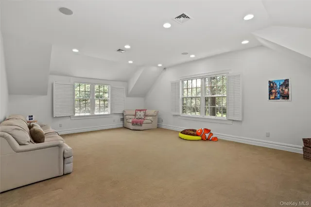 a living room with furniture gym equipment and a window