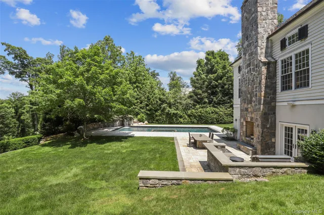 a view of a house with backyard sitting area and garden