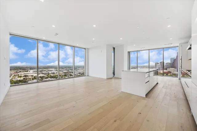 a large white kitchen with a large window