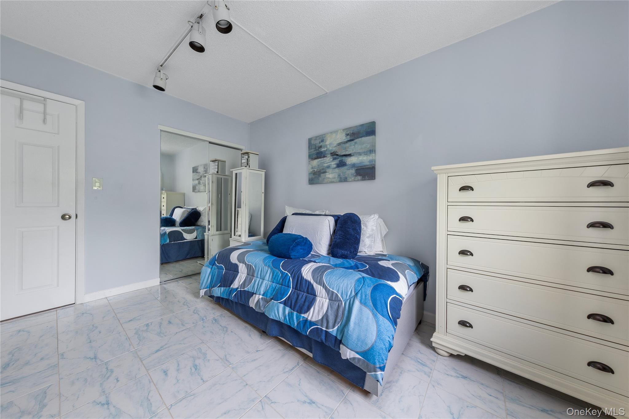 71-28 Sutton Place, Unit 3 Queens, NY 11365 - Photo 12 of 23 Bedroom featuring marble look tile flooring and baseboards