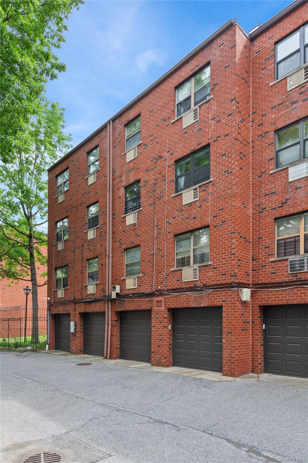 71-28 Sutton Place, Unit 3 Queens, NY 11365 - Photo 20 of 23 View of building exterior featuring an attached garage