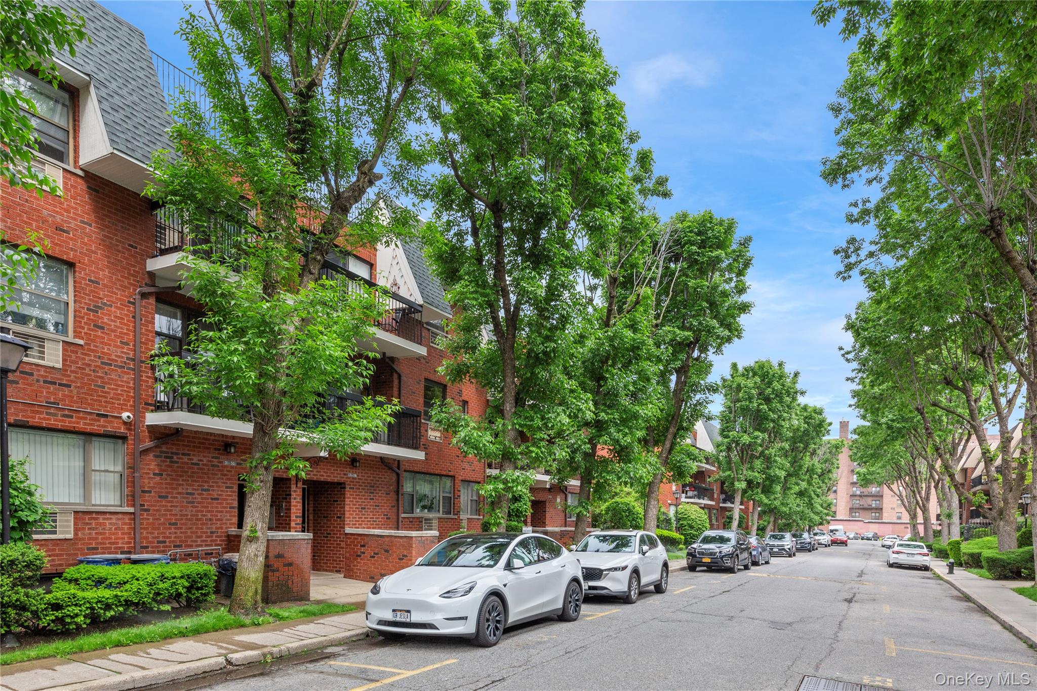 71-28 Sutton Place, Unit 3 Queens, NY 11365 - Photo 21 of 23 View of asphalt road featuring curbs and sidewalks