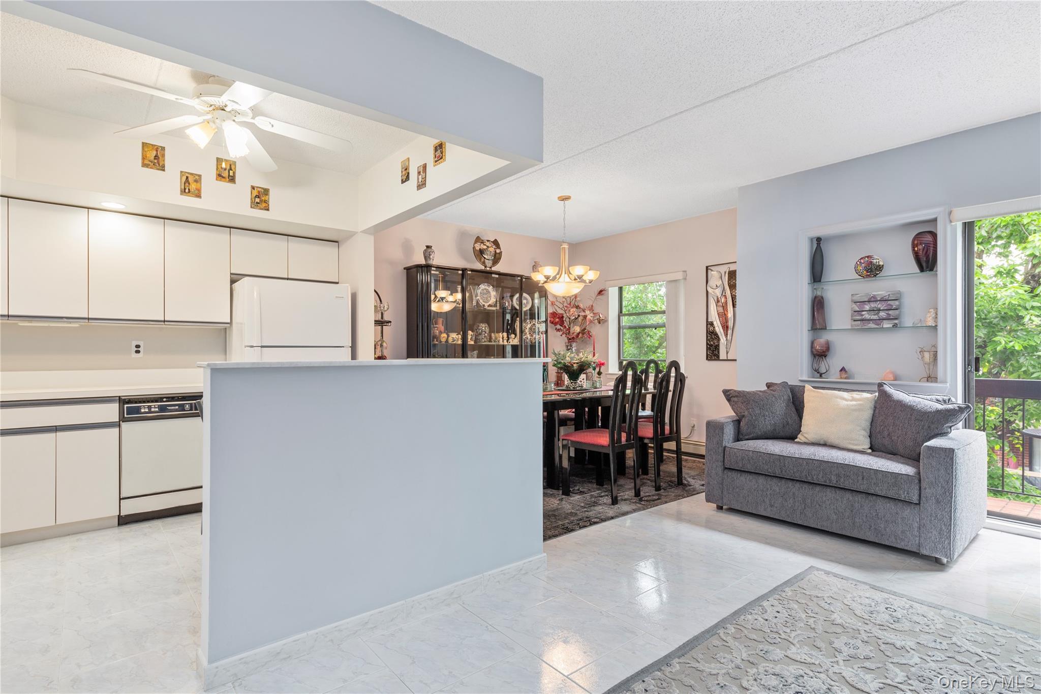 71-28 Sutton Place, Unit 3 Queens, NY 11365 - Photo 5 of 23 Kitchen with white appliances, a chandelier, plenty of natural light, and white cabinetry