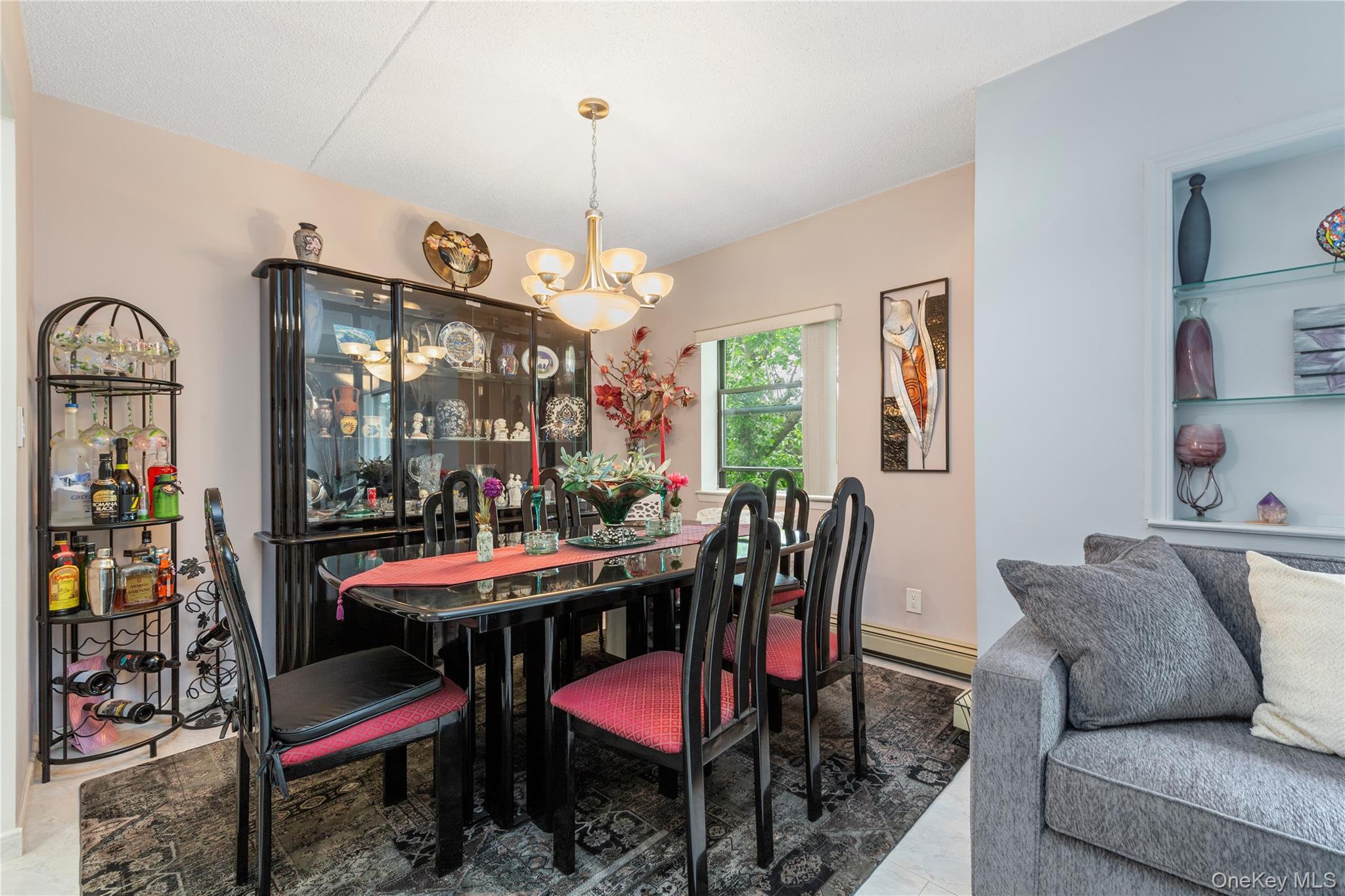 71-28 Sutton Place, Unit 3 Queens, NY 11365 - Photo 6 of 23 Tiled dining room with a chandelier and baseboard heating
