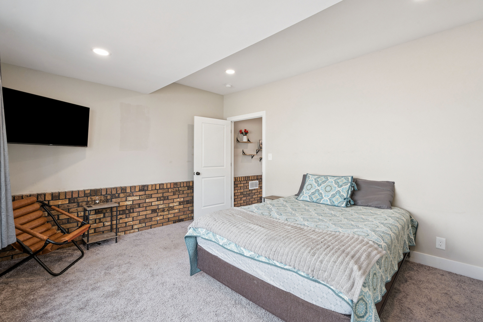 2052 37th Street Rock Island, IL 61201 - Photo 11 of 28 a spacious bedroom with a bed and a flat screen tv