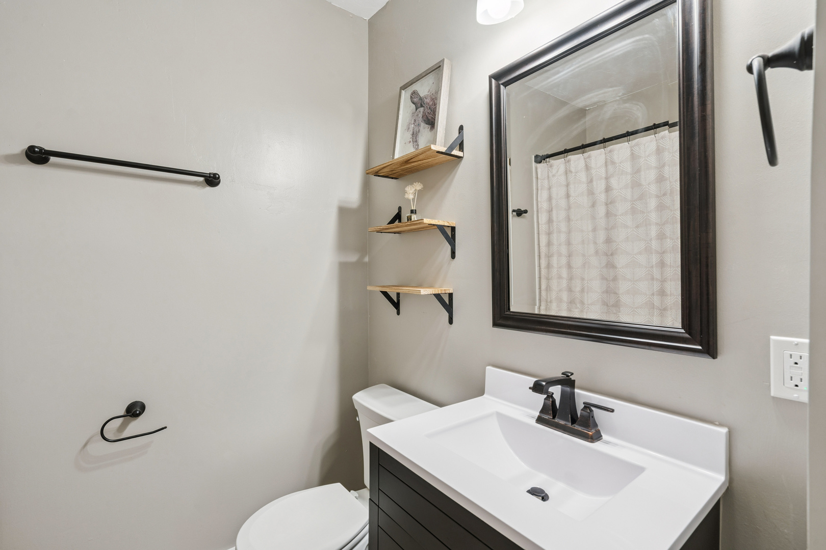 2052 37th Street Rock Island, IL 61201 - Photo 13 of 28 a bathroom with a sink mirror and toilet