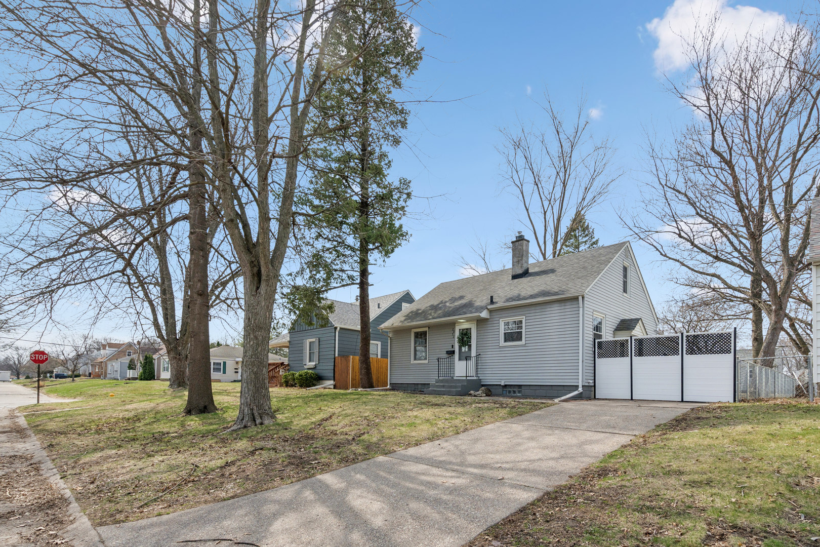 2052 37th Street Rock Island, IL 61201 - Photo 2 of 28 a white house that has a tree in front of it