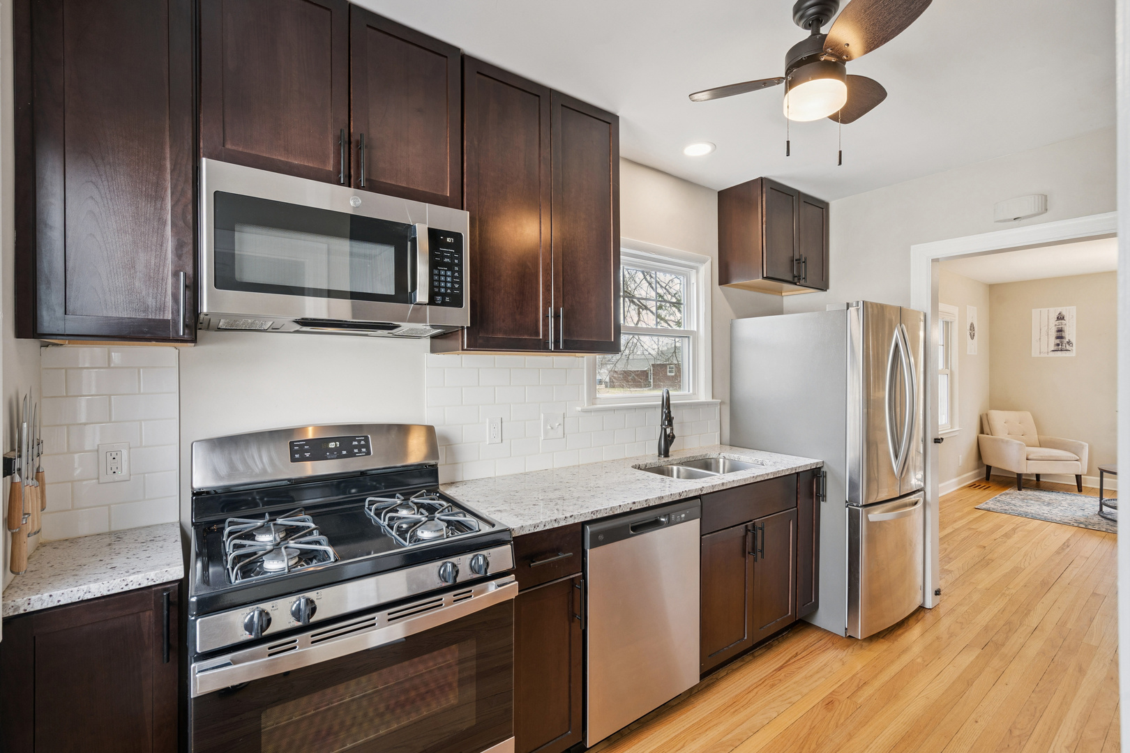 2052 37th Street Rock Island, IL 61201 - Photo 6 of 28 a kitchen with stainless steel appliances granite countertop a stove refrigerator and microwave