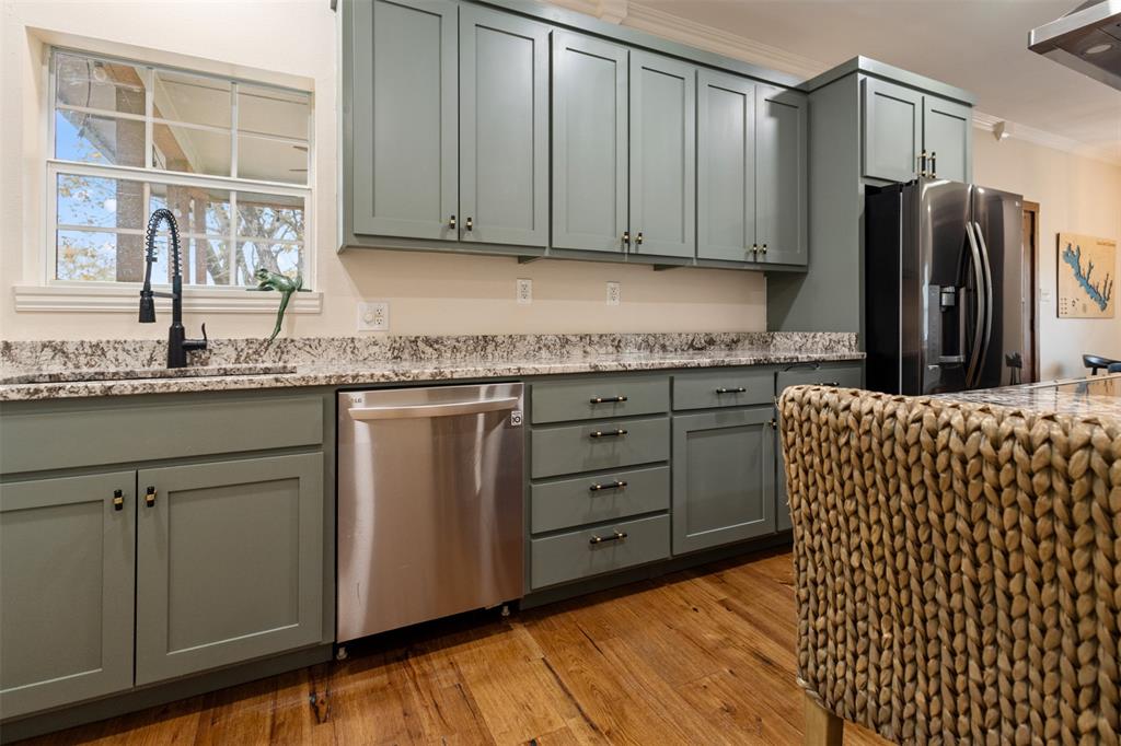 106 White Oak Mabank, TX 75156 - Photo 11 of 32 a kitchen with stainless steel appliances granite countertop a sink a stove a refrigerator and cabinets