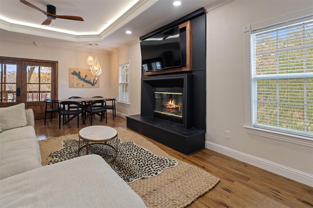 106 White Oak Mabank, TX 75156 - Photo 7 of 32 a living room with furniture a fireplace and a flat screen tv