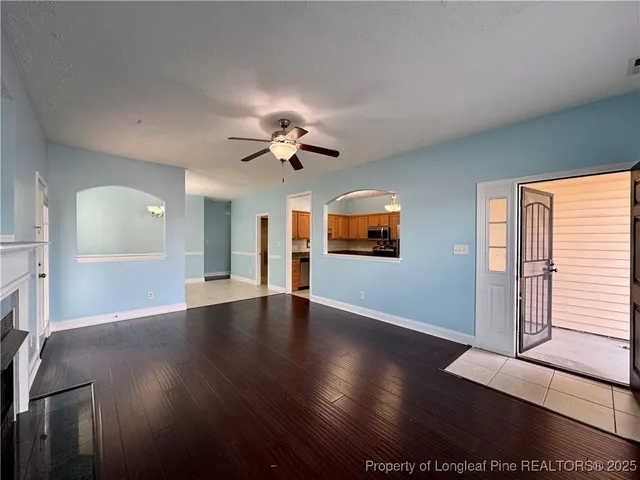a view of livingroom with hardwood floor and ceiling fan