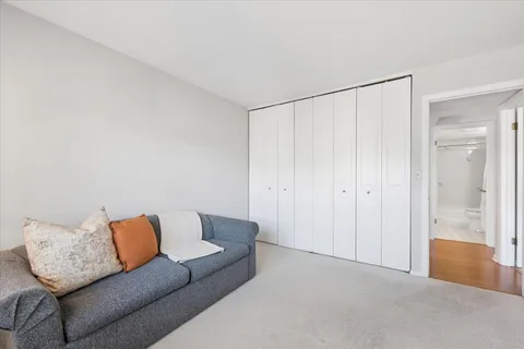 a living room with a couch and a ceiling fan