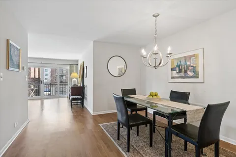 a view of a dining room with furniture wooden floor and chandelier