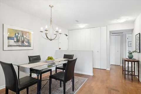 a view of a dining room with furniture wooden floor and a chandelier