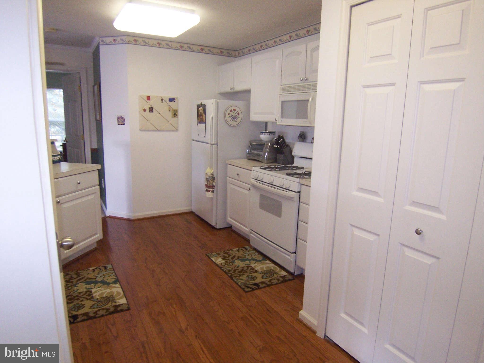 3012 Hunting Ridge Drive, Unit 3012 Owings Mills, MD 21117 - Photo 3 of 11 Kitchen w/Hardwood Floors