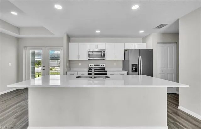 a kitchen with stainless steel appliances a refrigerator sink and stove