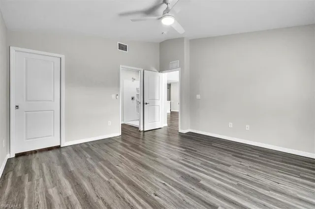 a view of an empty room with wooden floor