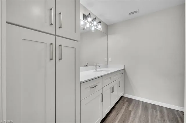 a bathroom with a double vanity sink and mirror