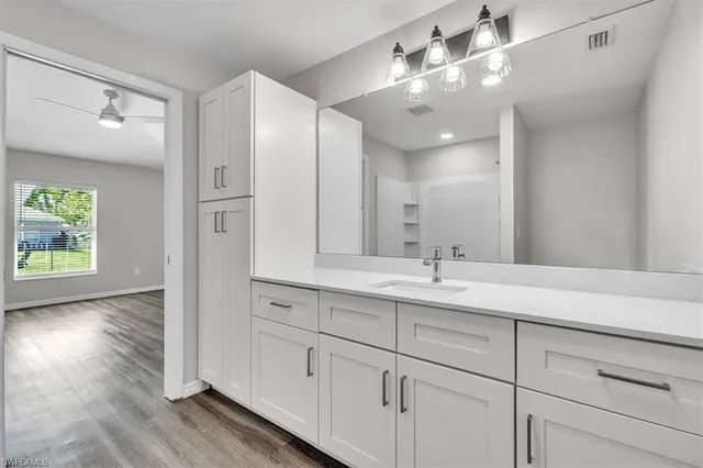 a bathroom with a double vanity sink and a mirror
