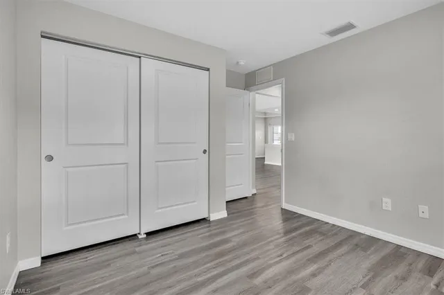 a view of an empty room and wooden floor