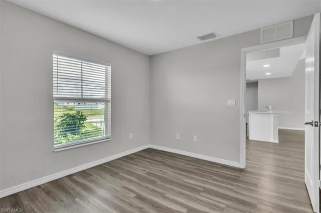 wooden floor in an empty room with a window