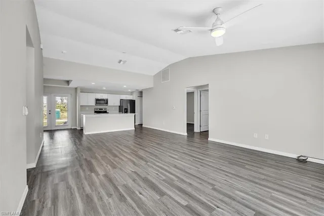 a view of empty room with wooden floor