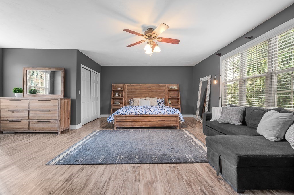 3 Carter Way Worcester, MA 01609 - Photo 15 of 41 a spacious bedroom with a large bed and a chandelier