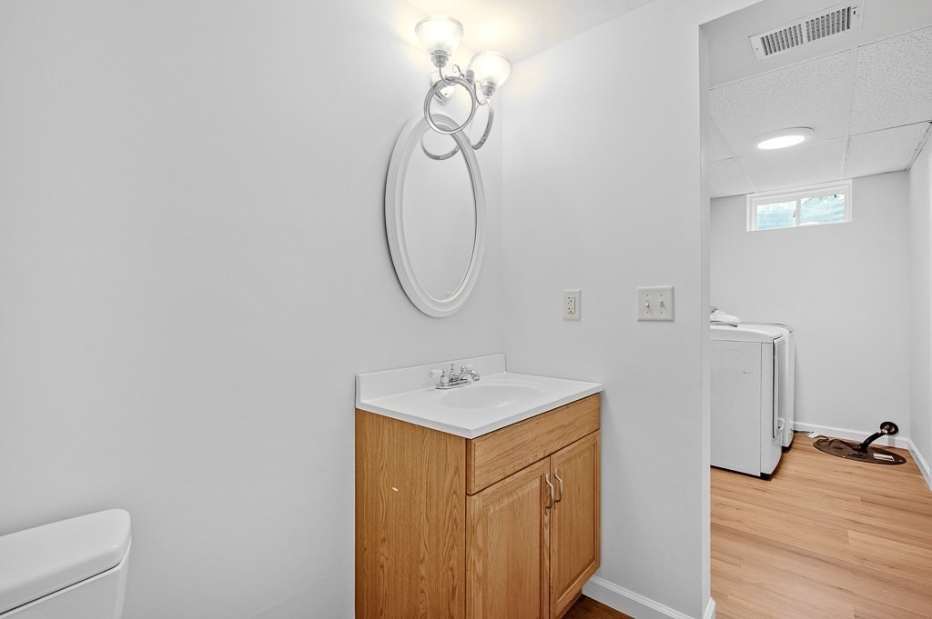 3 Carter Way Worcester, MA 01609 - Photo 31 of 41 a bathroom with a sink a light fixture and a mirror