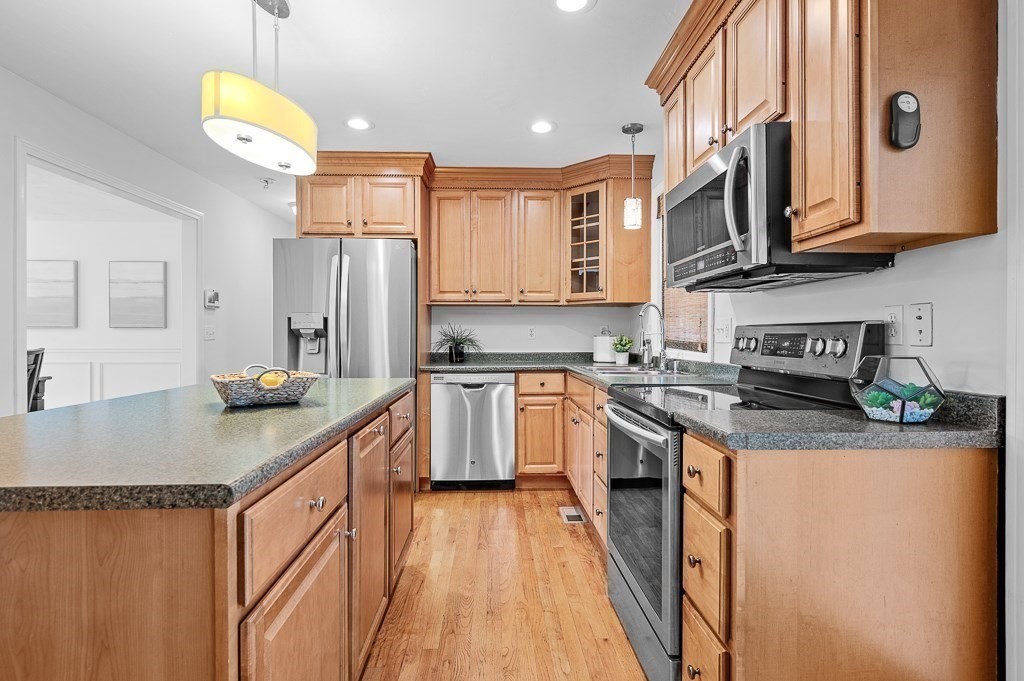 3 Carter Way Worcester, MA 01609 - Photo 8 of 41 a kitchen with stainless steel appliances granite countertop a sink a stove a refrigerator cabinets and a dining table