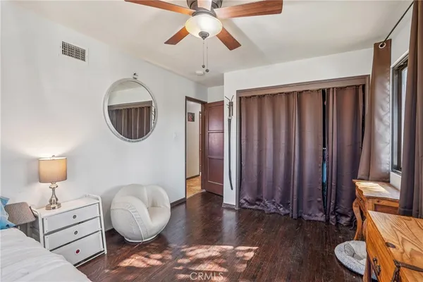 a bedroom with a bed and a dresser in it