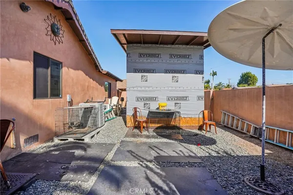 a palm tree sitting in front of a building