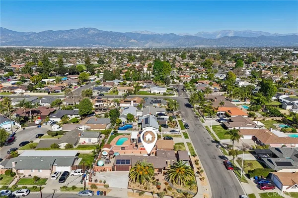 an aerial view of a house with a yard and sitting area