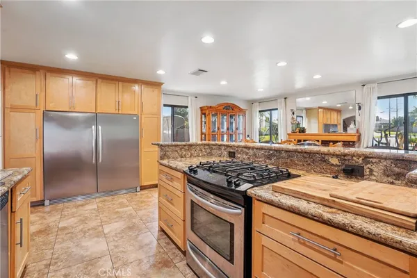 a view of a dining room with furniture and a kitchen