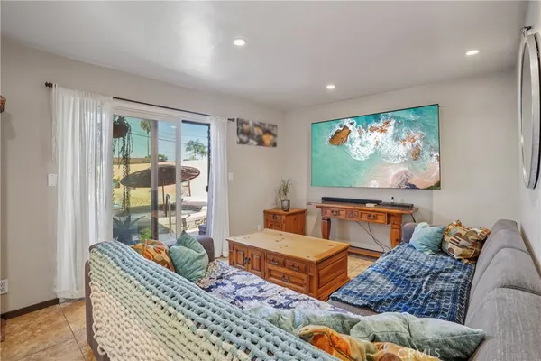 a bedroom with a bed a dresser and chair