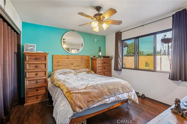 a bedroom with a bed and wooden floor