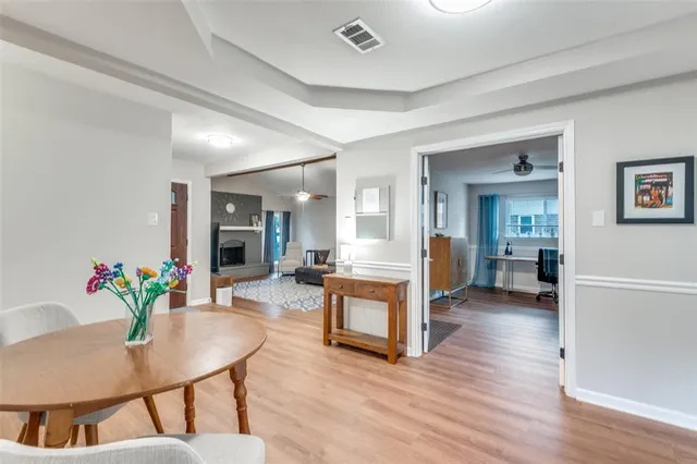 a living room with furniture and a dining table