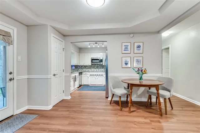 a workspace with wooden floor and a kitchen
