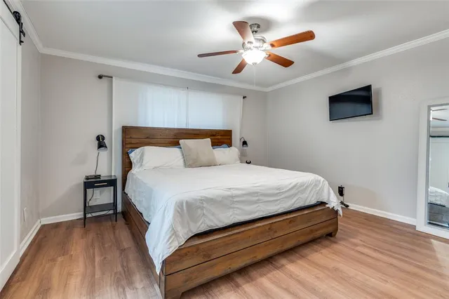 a bedroom with a bed and a ceiling fan
