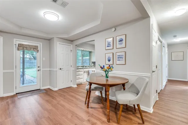 a view of a dining room with furniture and wooden floor