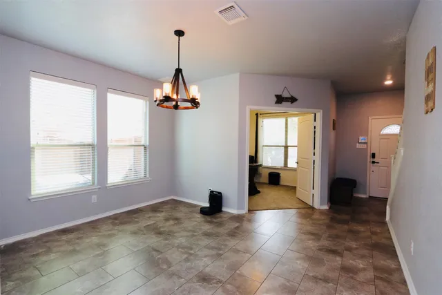 a living room with fireplace furniture and a chandelier