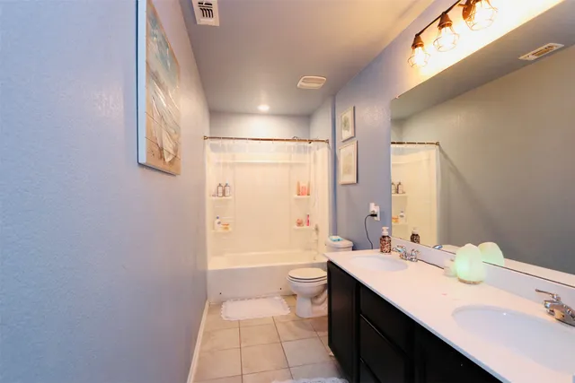 a bedroom with a bed and a chandelier fan