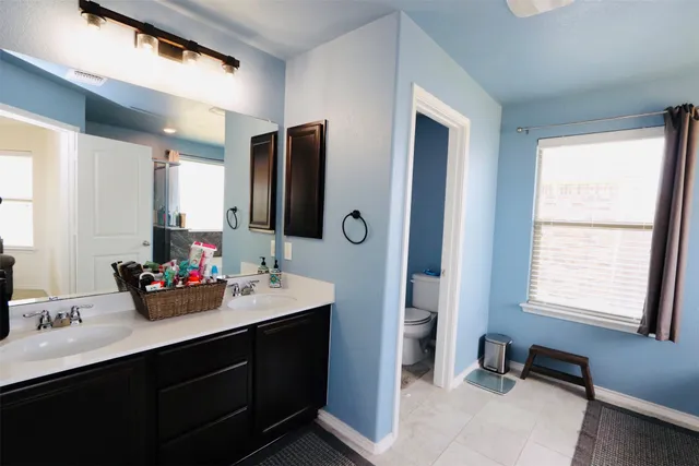 a living room with furniture a flat screen tv and a window