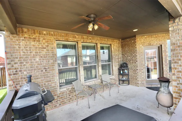 a view of a white house with a yard and table and chairs