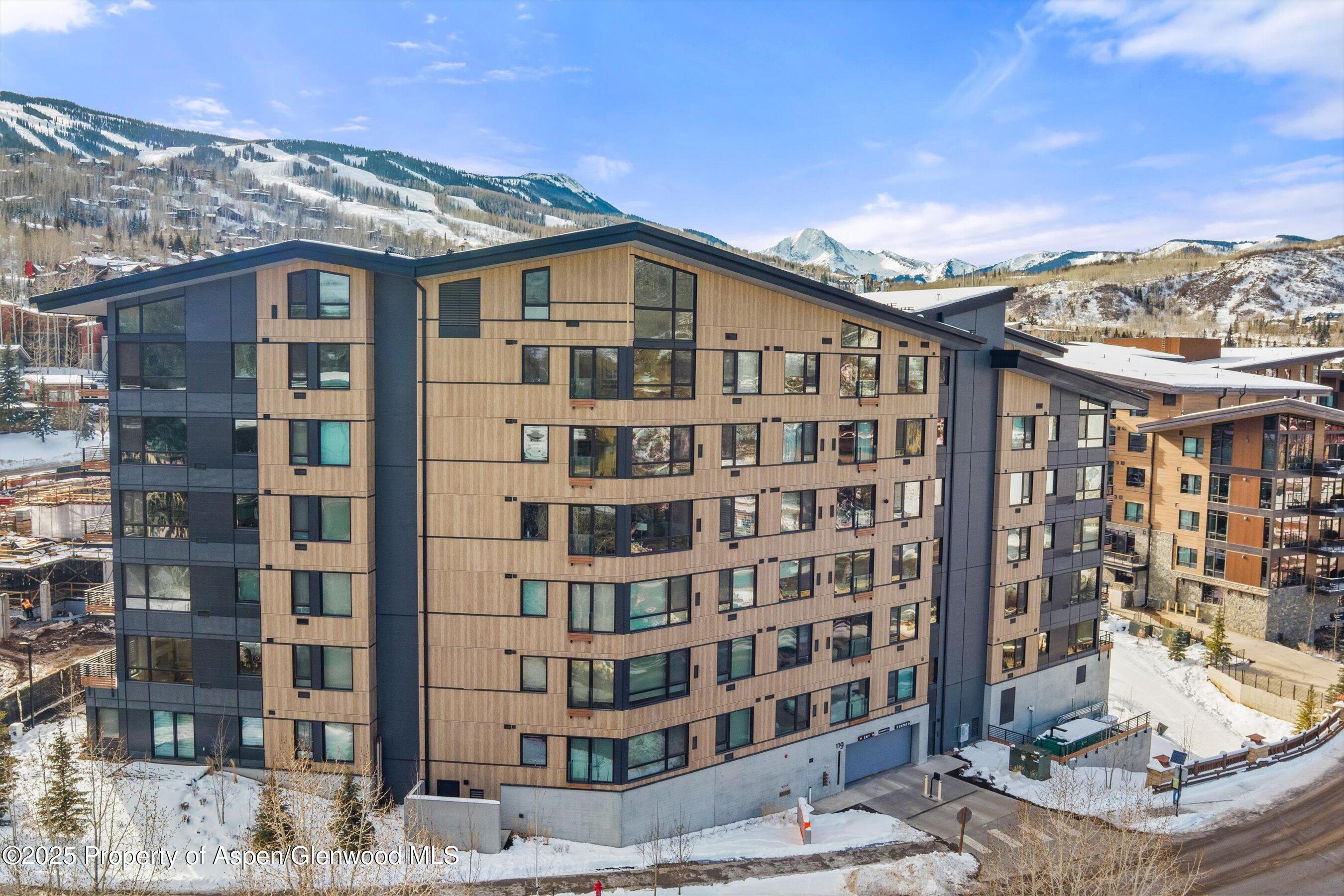 119 Wood Road, Unit 403 Snowmass Village, CO 81615 - Photo 15 of 27 a large building with a lot of windows