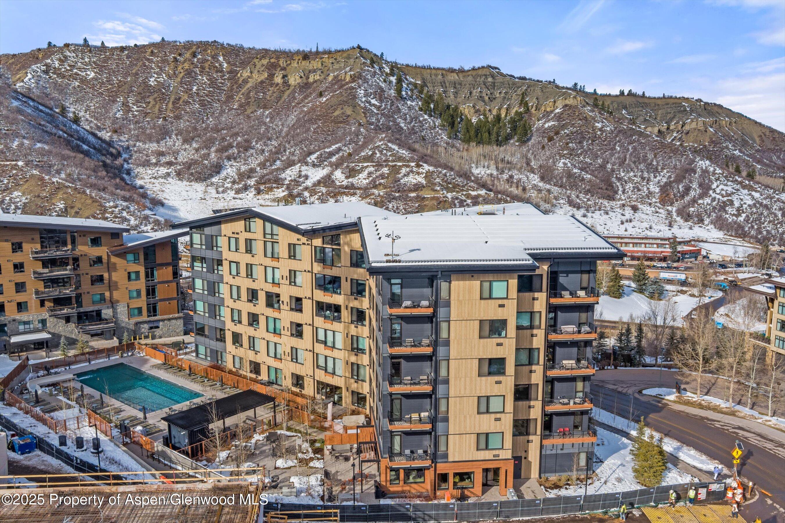 119 Wood Road, Unit 403 Snowmass Village, CO 81615 - Photo 16 of 27 a front view of a building with a mountain