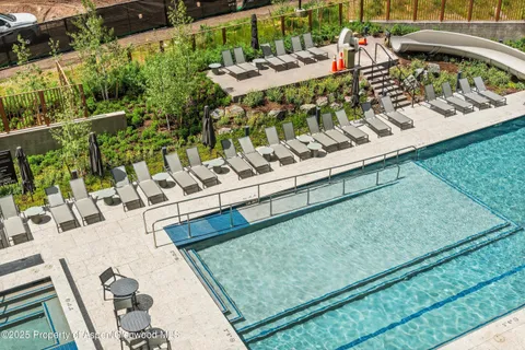 a view of swimming pool with outdoor seating