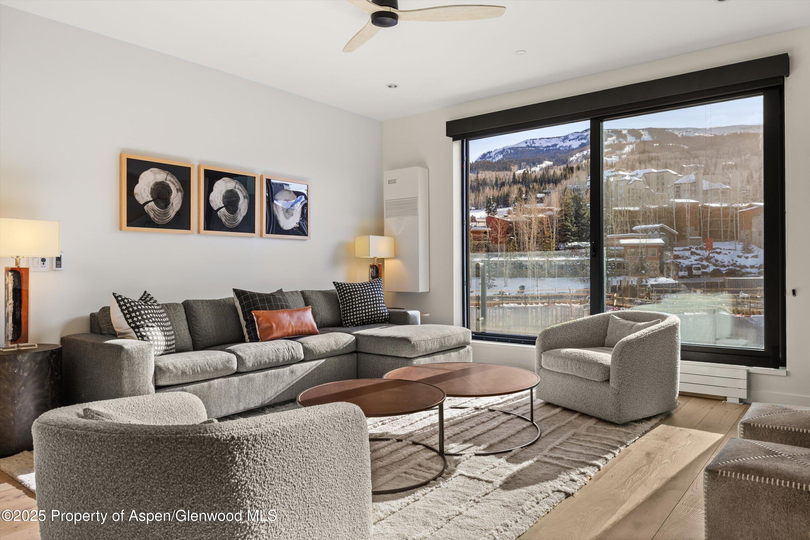 119 Wood Road, Unit 403 Snowmass Village, CO 81615 - Photo 6 of 27 a living room with furniture and a large window