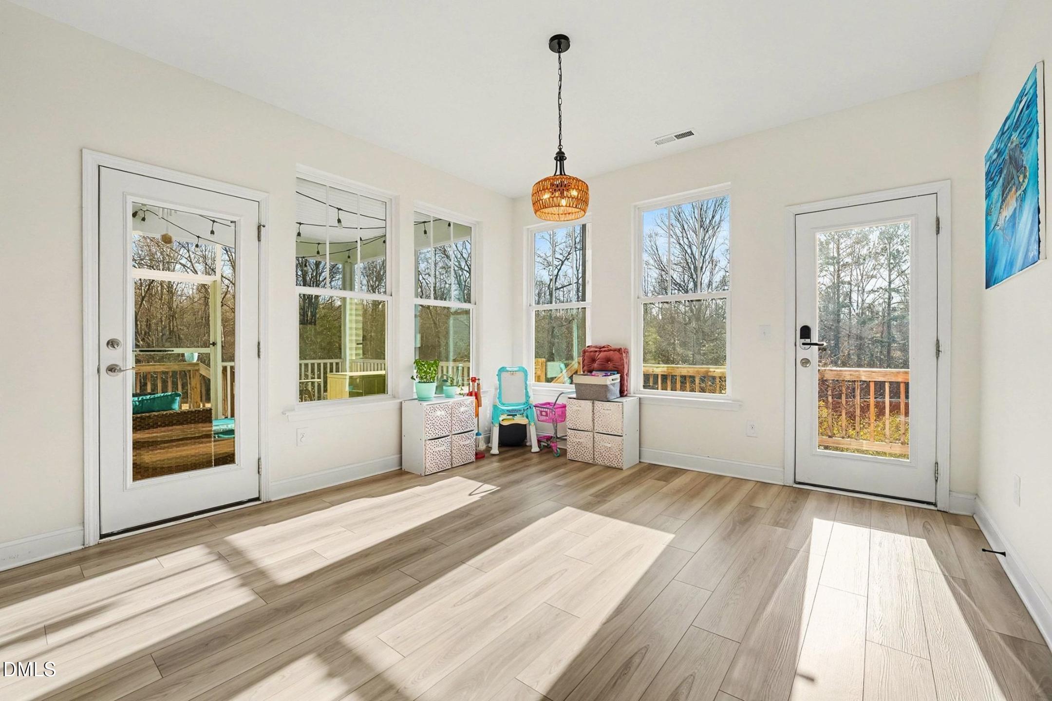 185 Twilight Trail Willow Spring, NC 27592 - Photo 13 of 42 a view of a room with wooden floor and windows